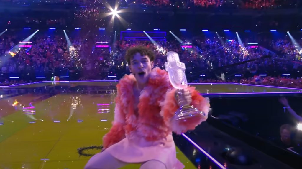 Eurovision winner Nemo holding their trophy