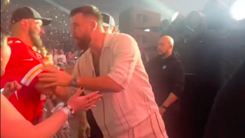 Travis Kelce hugs a Kansas City Chiefs fan at the Eras Tour in Paris