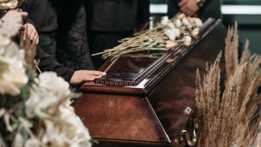 Family gather around a casket at a funeral