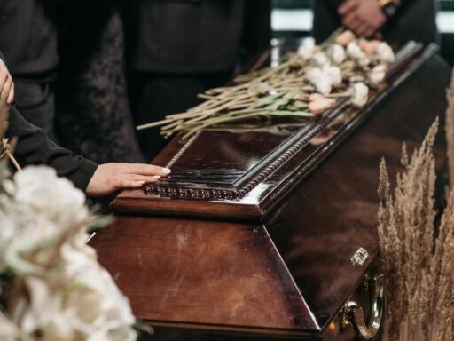 Family gather around a casket at a funeral