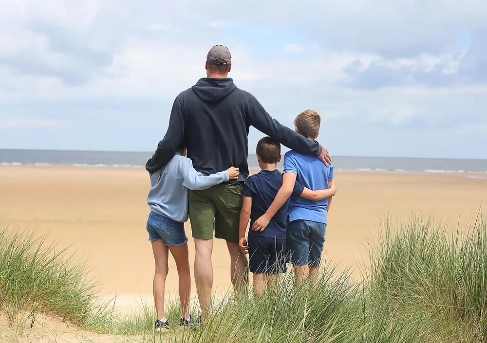 Prince William poses with his children on Father's Day at a beach in Norfolk