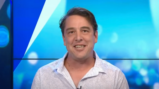 samuel Johnson wears a white shirt and smiles at the camera