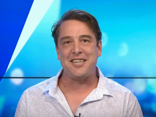 samuel Johnson wears a white shirt and smiles at the camera