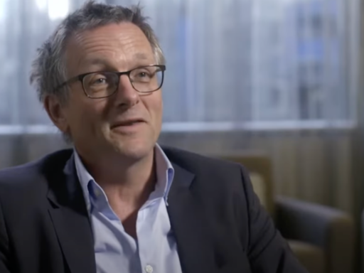 Dr Michael Moseley sits in an armchair, wearing glasses