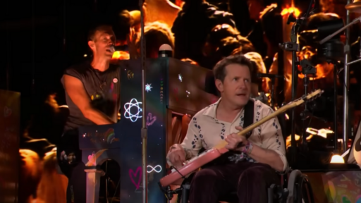 Michael J Fox playing with Coldplay on stage at Glastonbury