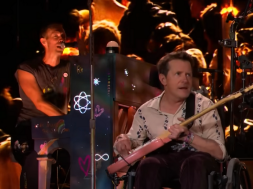 Michael J Fox playing with Coldplay on stage at Glastonbury