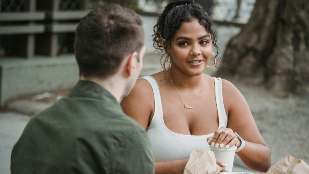 Woman eating with her friend at a table